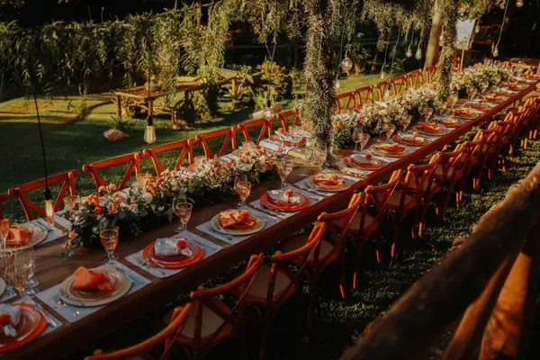 Long communal dinner table on a rooftop in Oaxaca at golden hour with the city's church domes in the background