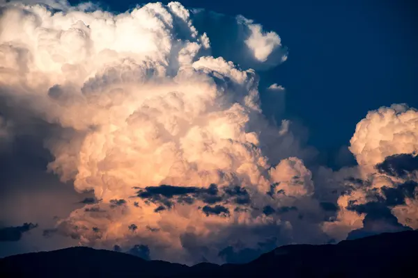 Late afternoon thunderstorm clouds gathering over the mountains around the Oaxaca valley